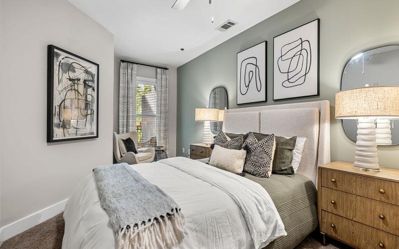 a bedroom with a bed and a lamp