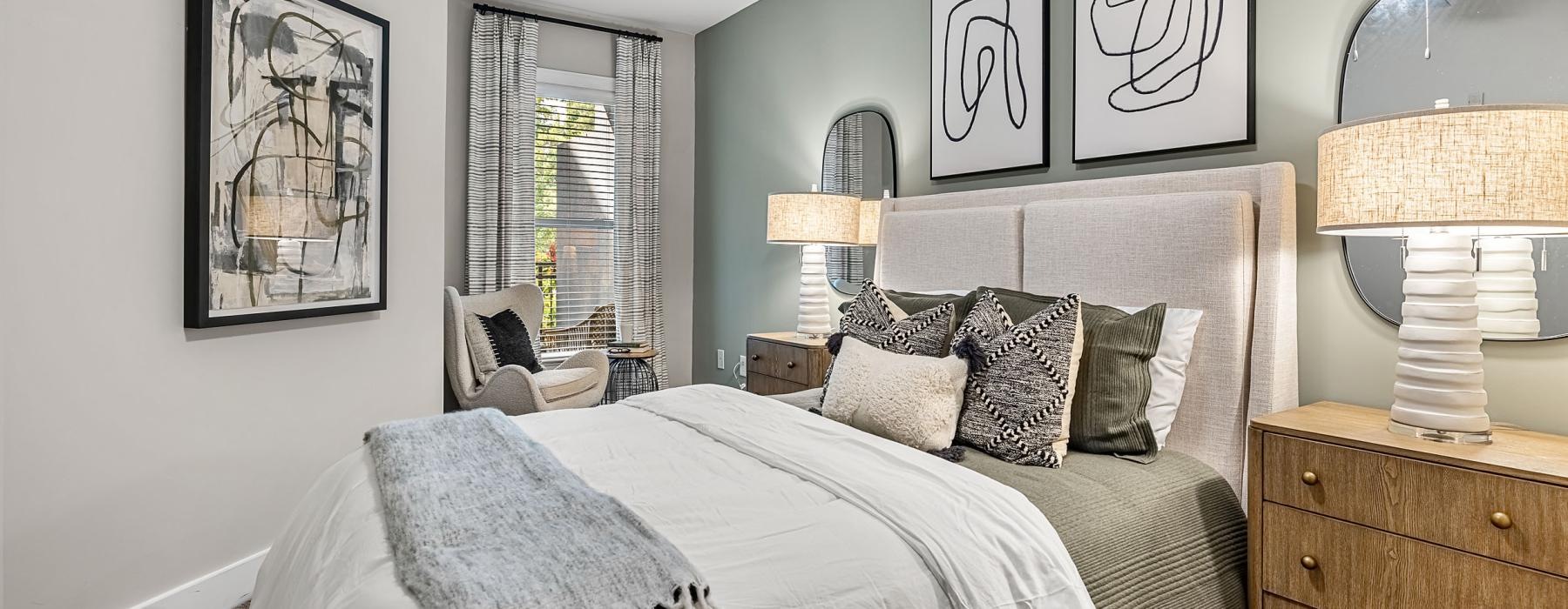 a bedroom with a bed and a lamp